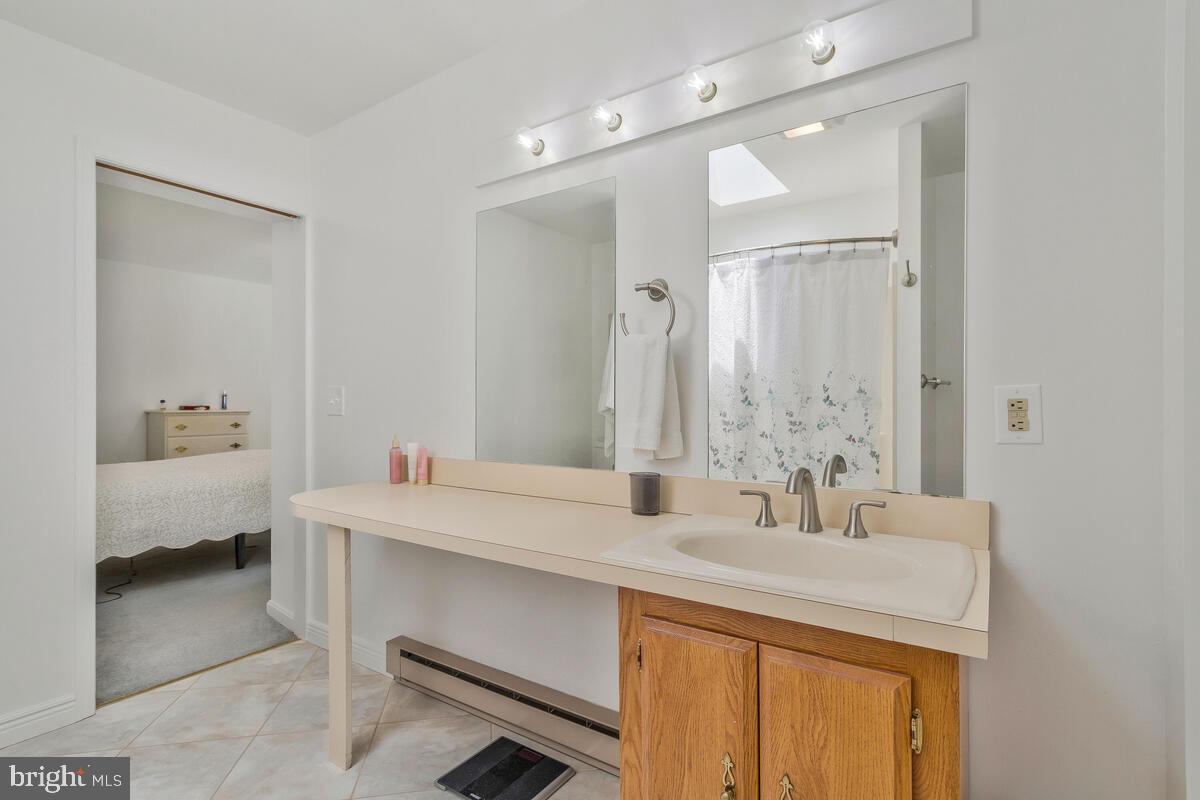 22 Robshire Manor Road Huntingtown, MD 20639 - Photo 21 of 44 a bathroom with a sink and a mirror