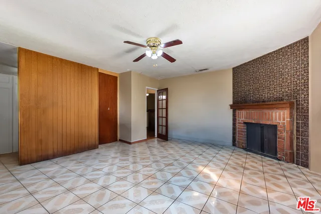 a view of empty room with a fireplace