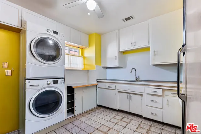 a kitchen with a sink a washer and dryer