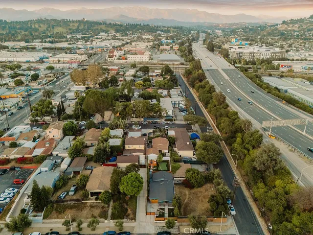 a bedroom with a bed and a lamp on dresser