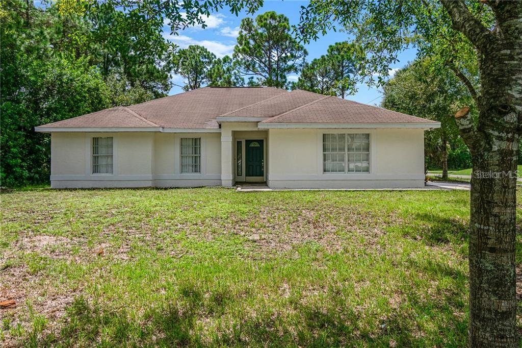 1298 Malabar Road Palm Bay, FL 32908 - Photo 1 of 1 a front view of house with yard and trees all around
