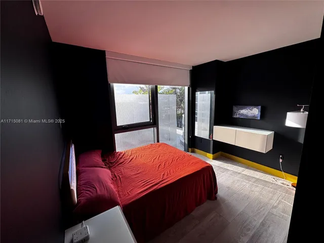 a bedroom with a bed and a television