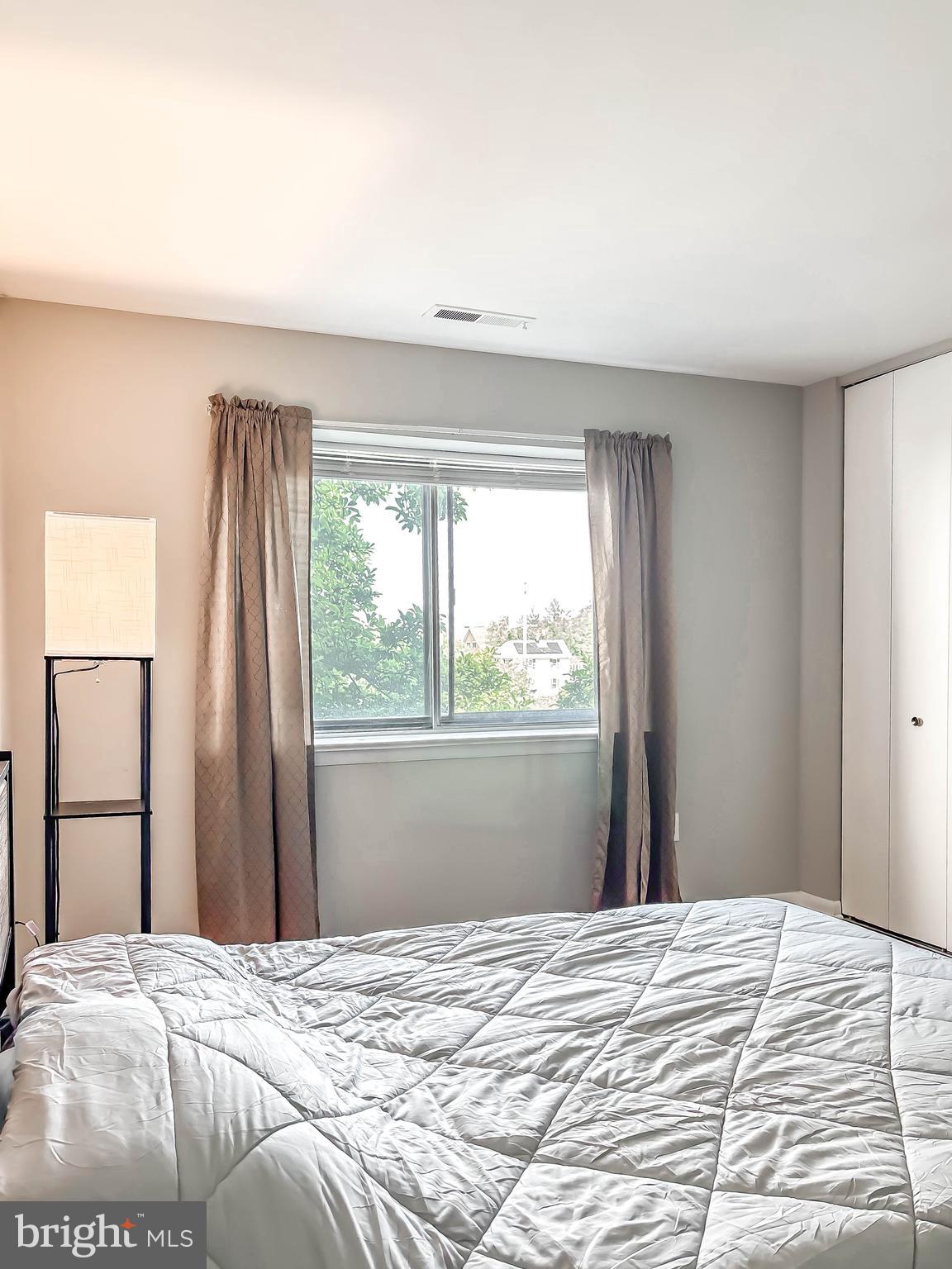 130 Slade Avenue, Unit 414 Baltimore, MD 21208 - Photo 16 of 48 a bedroom with a bed and a window