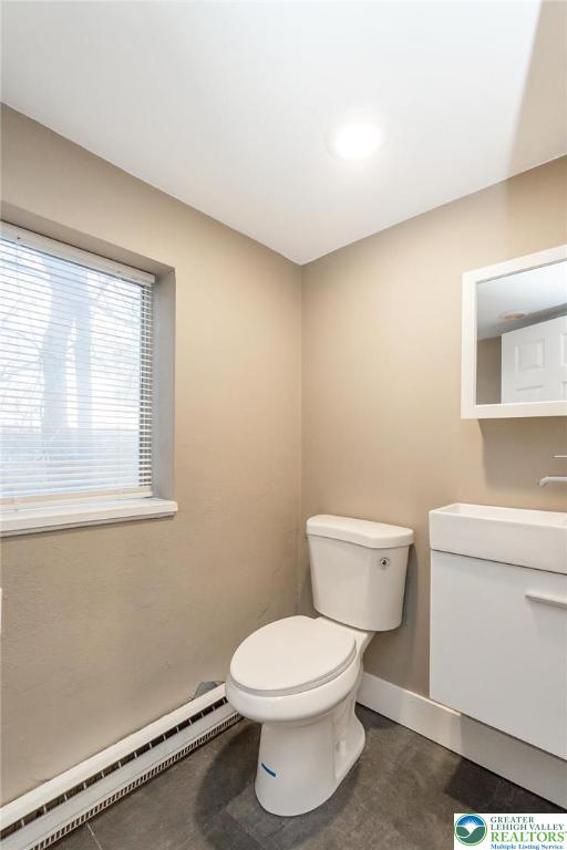 7243 Kingstead Drive Slatington, PA 18080 - Photo 33 of 36 a white toilet sitting next to a bathroom sink and vanity