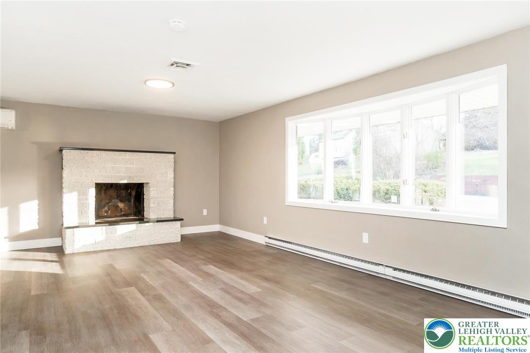 7243 Kingstead Drive Slatington, PA 18080 - Photo 6 of 36 an empty room with windows and fireplace