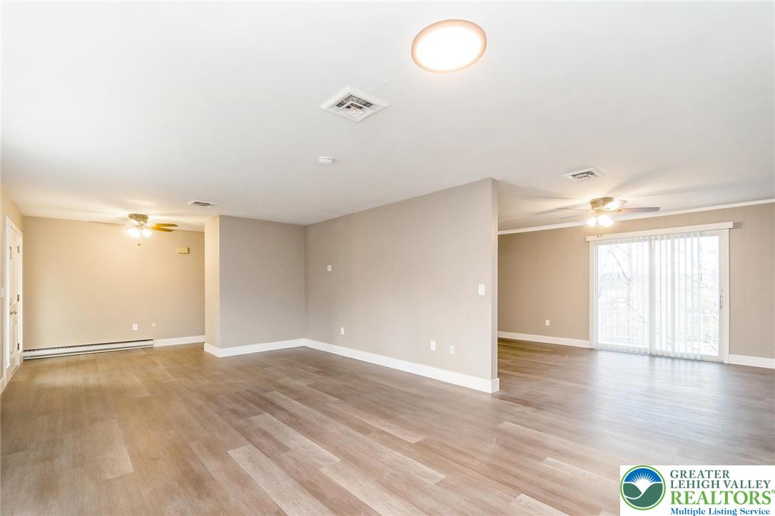 7243 Kingstead Drive Slatington, PA 18080 - Photo 8 of 36 a view of an empty room with window and wooden floor