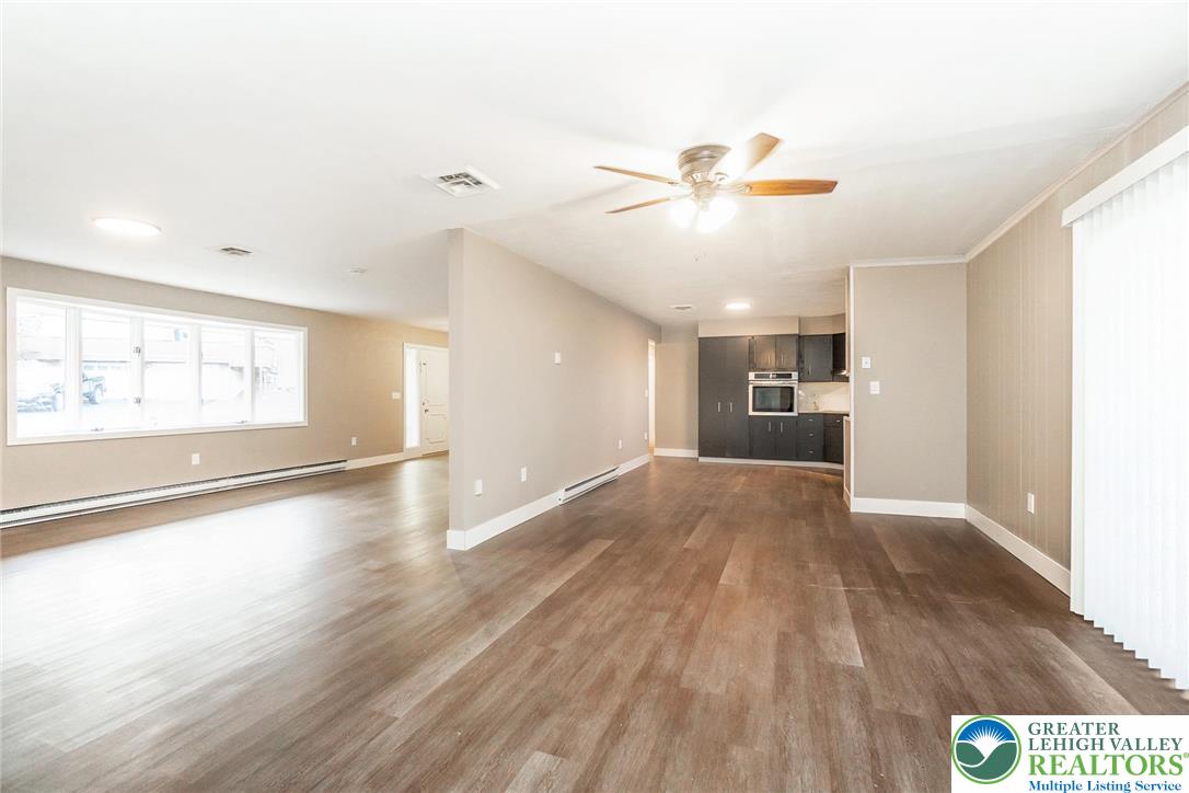 7243 Kingstead Drive Slatington, PA 18080 - Photo 9 of 36 a view of an empty room with a window and wooden floor