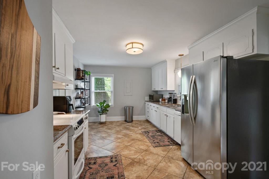 4326 Castleton Road Charlotte, NC 28211 - Photo 11 of 33 a kitchen with a refrigerator and a stove
