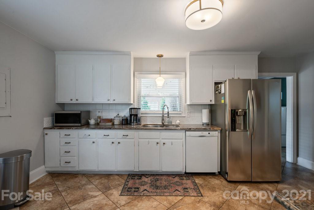 4326 Castleton Road Charlotte, NC 28211 - Photo 12 of 33 a kitchen with stainless steel appliances granite countertop a refrigerator a sink and white cabinets