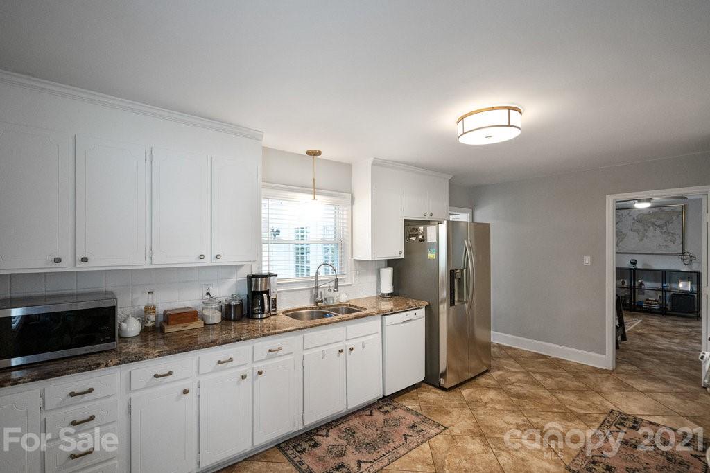 4326 Castleton Road Charlotte, NC 28211 - Photo 13 of 33 a kitchen with granite countertop a refrigerator and a sink