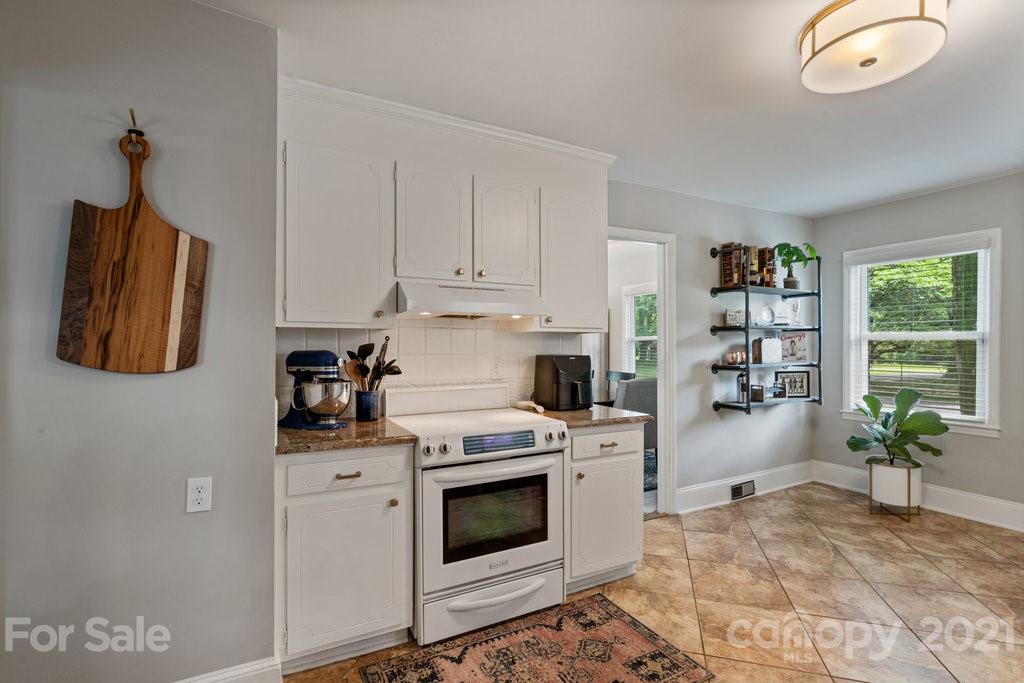 4326 Castleton Road Charlotte, NC 28211 - Photo 14 of 33 a kitchen with stainless steel appliances granite countertop a stove a sink and a refrigerator