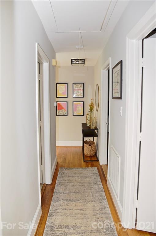4326 Castleton Road Charlotte, NC 28211 - Photo 18 of 33 a view of a hallway with wooden floor and furniture