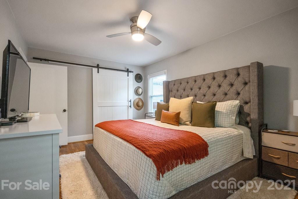 4326 Castleton Road Charlotte, NC 28211 - Photo 20 of 33 a bedroom with a bed and a flat screen tv