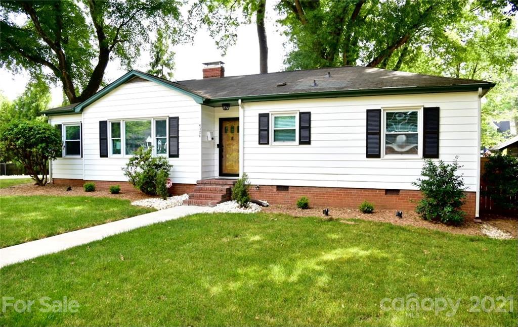 4326 Castleton Road Charlotte, NC 28211 - Photo 25 of 33 a front view of a house with a yard and potted plants