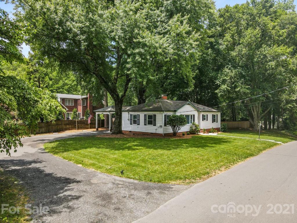 4326 Castleton Road Charlotte, NC 28211 - Photo 29 of 33 a front view of a house with a garden and trees