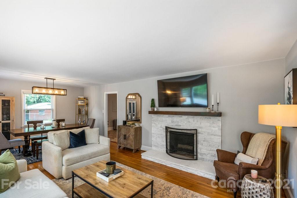 4326 Castleton Road Charlotte, NC 28211 - Photo 5 of 33 a living room with furniture a flat screen tv and a fireplace