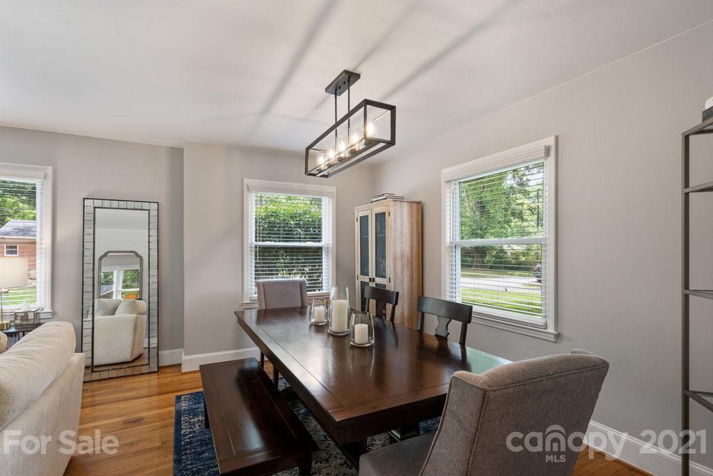 4326 Castleton Road Charlotte, NC 28211 - Photo 10 of 33 a dining room with furniture a chandelier and wooden floor