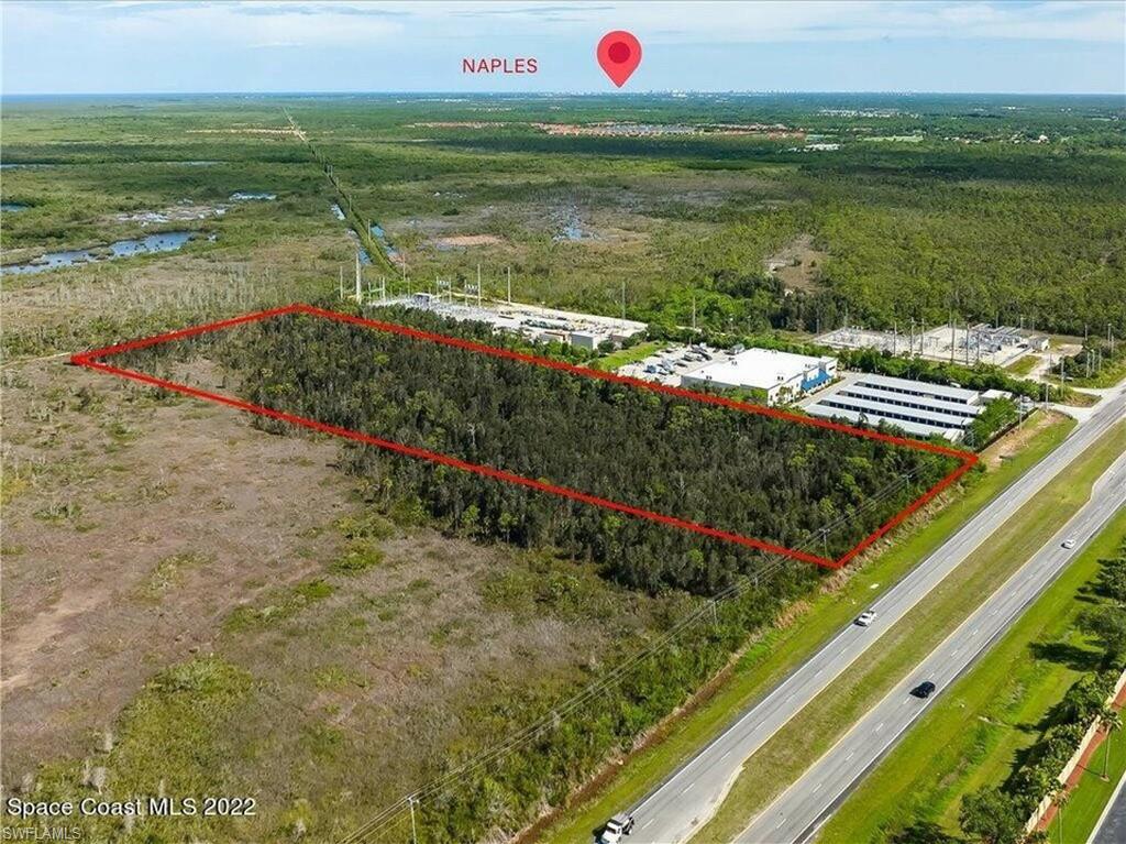 0 Collier Boulevard Naples, FL 34114 - Photo 6 of 8 a view of a lake with a floor to ceiling window and lake view