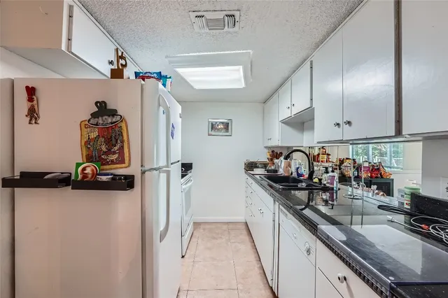 a kitchen with sink cabinets and appliances