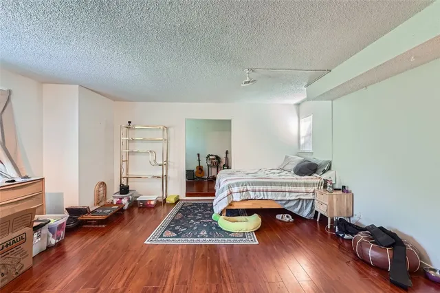 a bedroom with furniture and a wooden floor