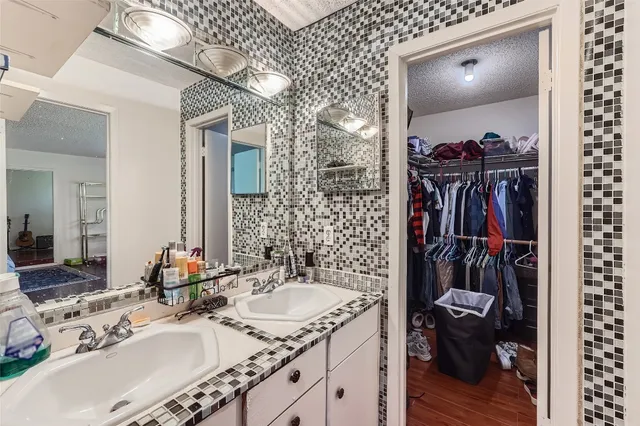 a bathroom with a sink vanity and a mirror