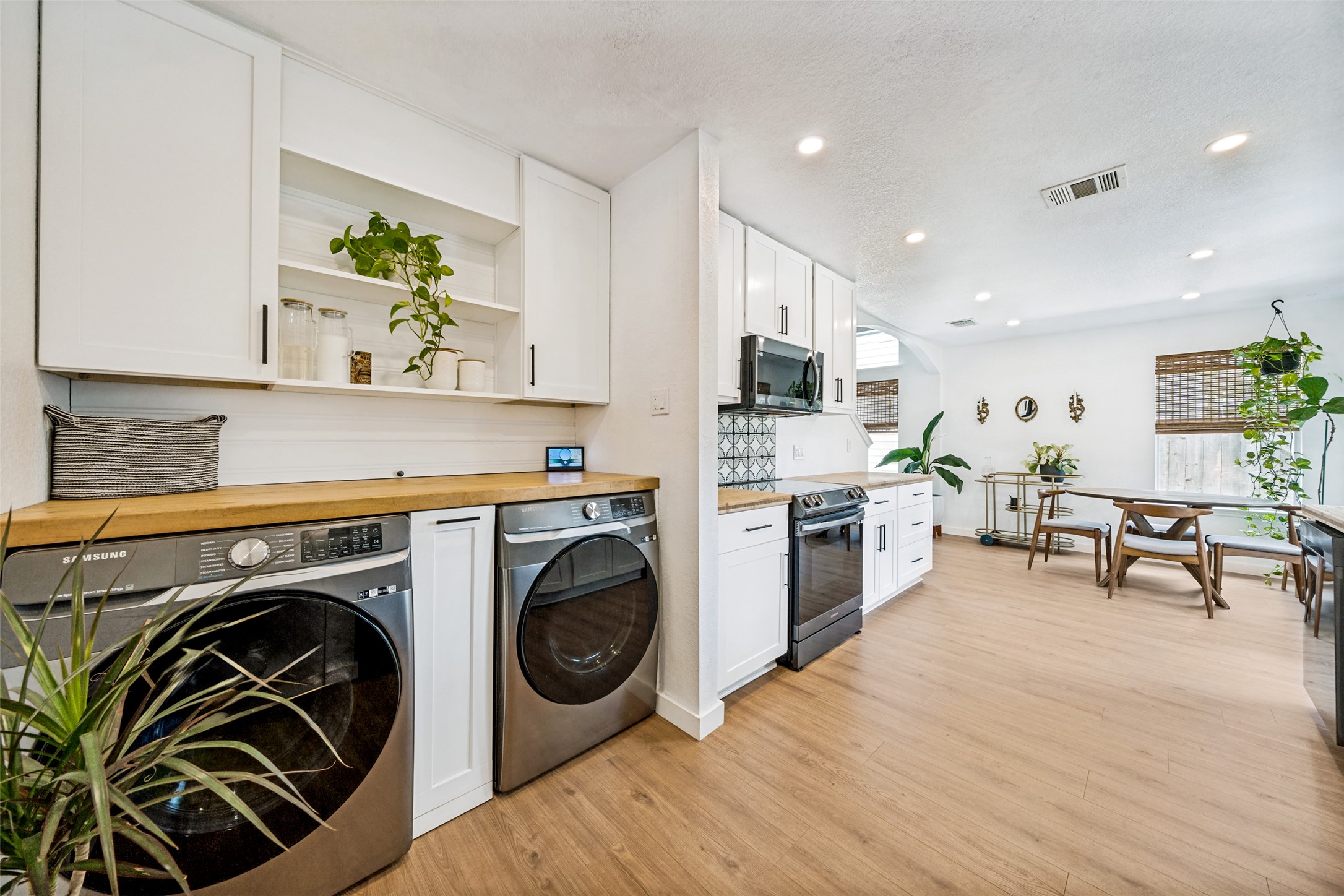 9205 Rowlands Sayle Road Austin, TX 78744 - Photo 25 of 25 A streamlined open floorplan provides both a modern kitchen and an integrated laundry space.