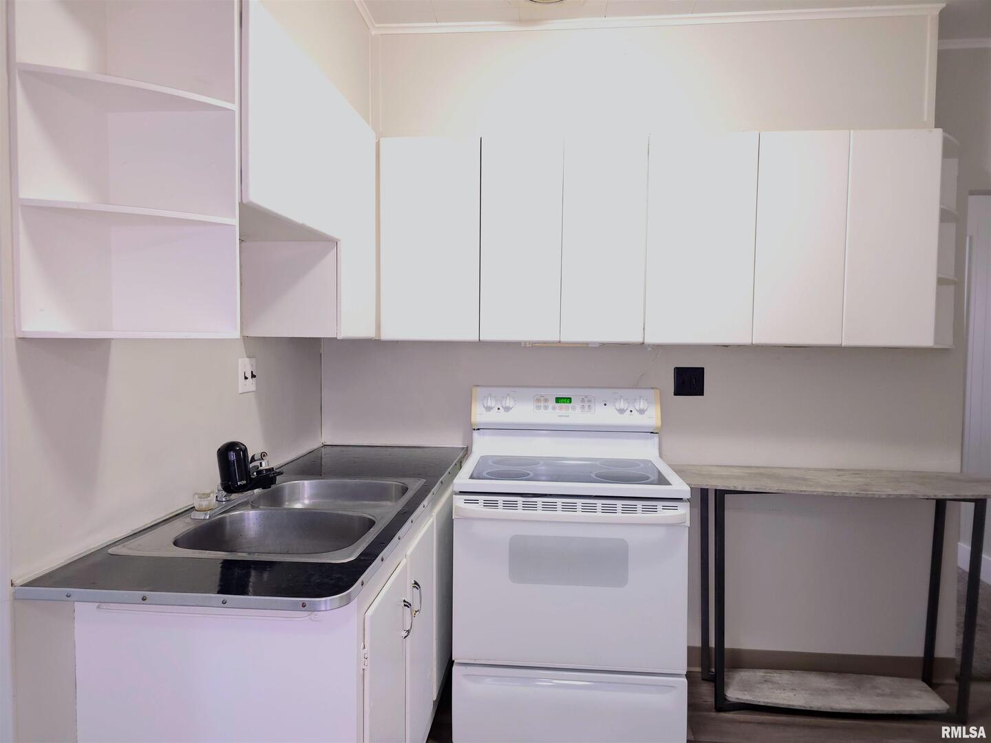 603 Adams Street Muscatine, IA 52761 - Photo 3 of 17 a kitchen with sink a stove and cabinets