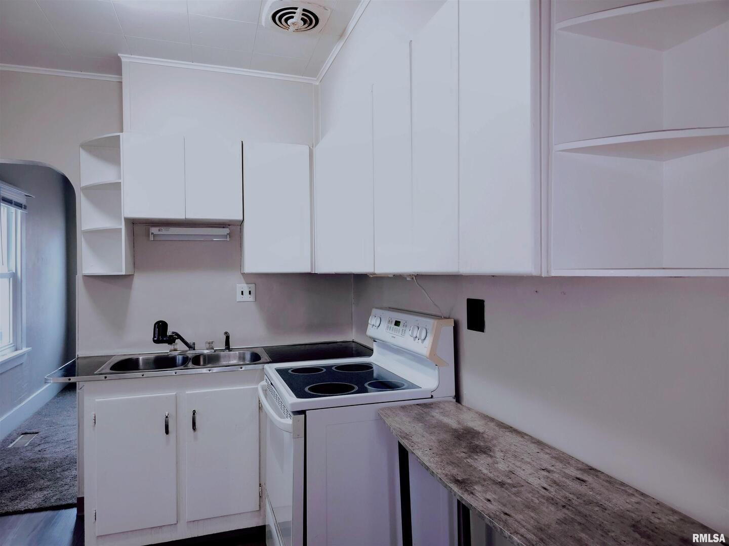 603 Adams Street Muscatine, IA 52761 - Photo 4 of 17 a kitchen with stainless steel appliances granite countertop white cabinets and a stove