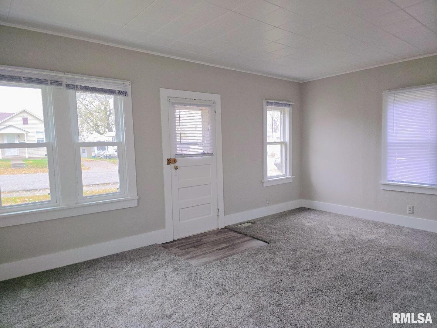 603 Adams Street Muscatine, IA 52761 - Photo 5 of 17 an empty room with windows