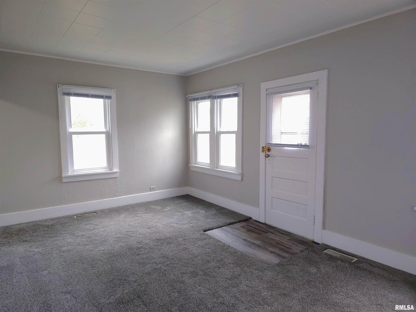 603 Adams Street Muscatine, IA 52761 - Photo 6 of 17 an empty room with windows