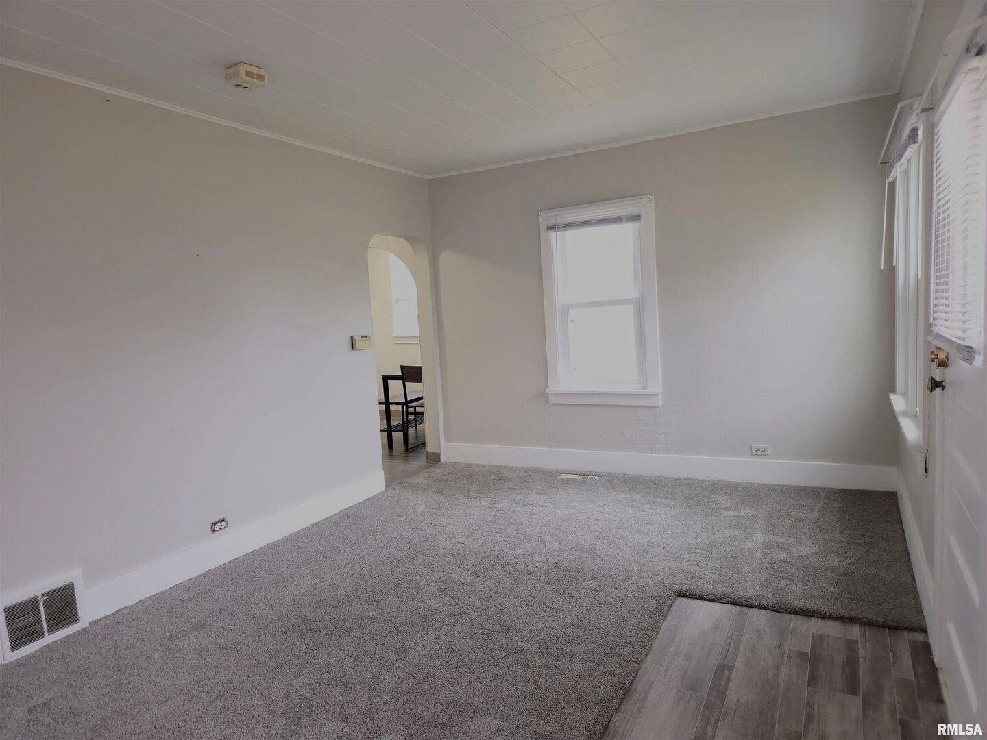 603 Adams Street Muscatine, IA 52761 - Photo 7 of 17 a view of an empty room with a window