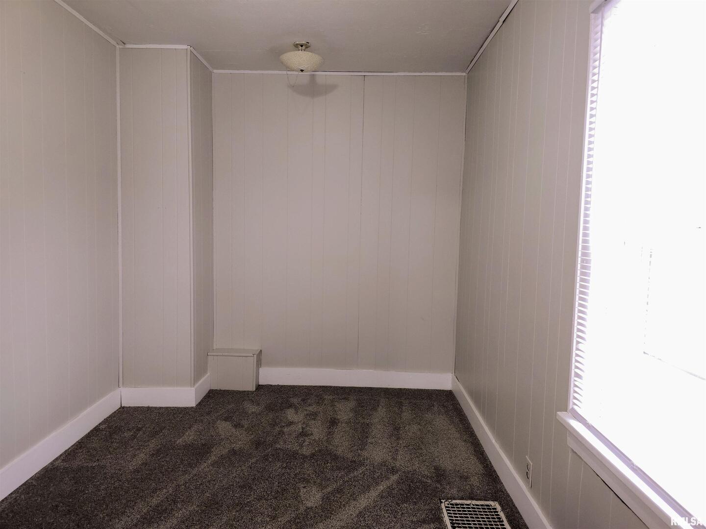 603 Adams Street Muscatine, IA 52761 - Photo 9 of 17 a view of a small space with wooden floor and a window