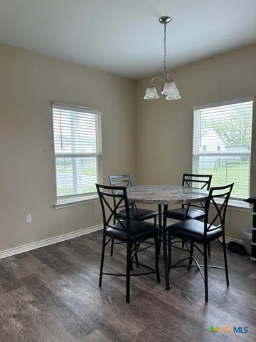 a dining room with furniture window and wooden floor