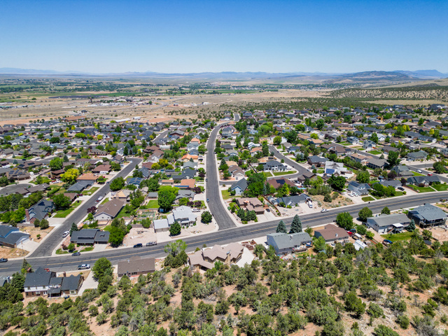 790 East Fiddlers Canyon Road Cedar City, UT 84721 - Photo 30 of 35 Expansive residential landscape featuring numerous single-family homes with diverse architectural styles, paved streets, and mature trees