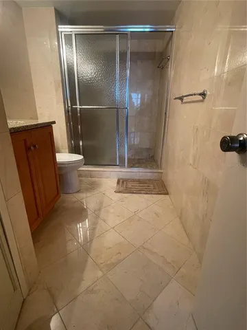 a bathroom with a shower and a toilet