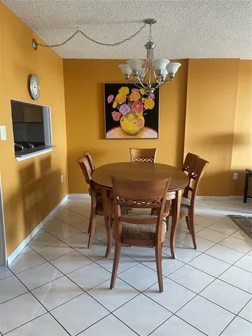 a view of a dining room with furniture and a flat screen tv