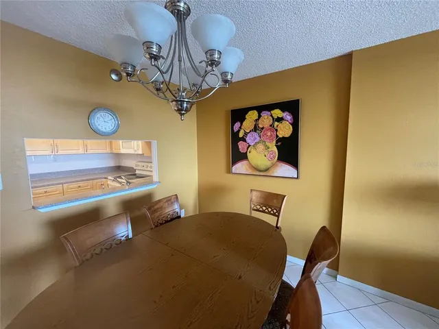 a view of a room with furniture and chandelier