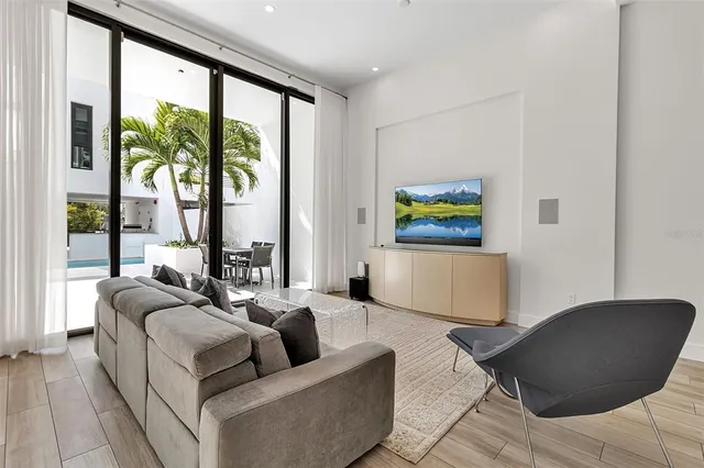 a living room with furniture and painting on the wall