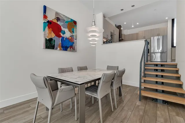 a kitchen with white cabinets and appliances