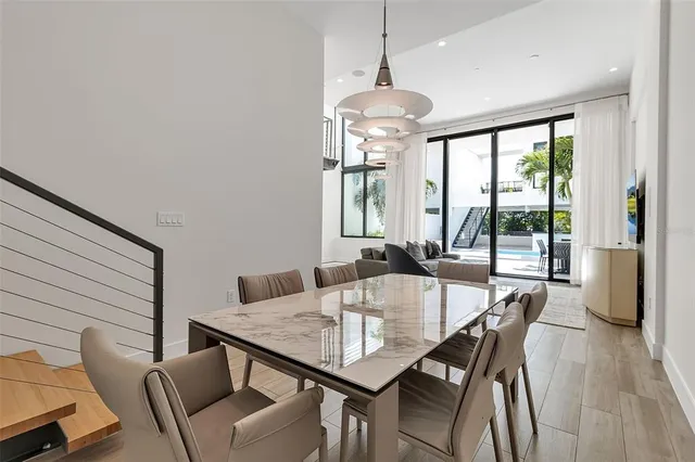 a view of a patio with table and chairs and potted plants