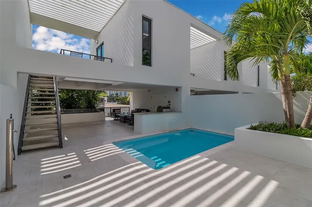 a view of a hallway with wooden floor and dining room