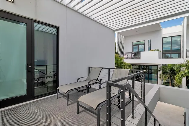 a hallway with wooden floor a rug and a window