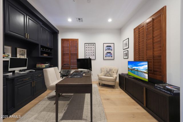 a living room with fireplace furniture and a wooden floor