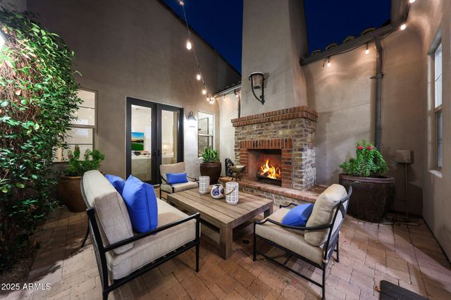 a large kitchen with stainless steel appliances kitchen island granite countertop a large kitchen island a stove a sink a dining table and chairs with wooden floor