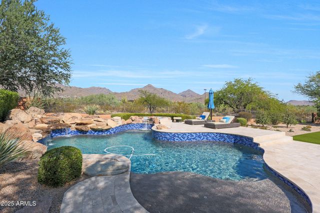 a living room with furniture a fireplace and a chandelier