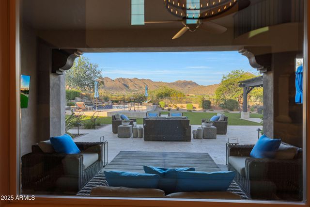 a living room with furniture a rug and a large window