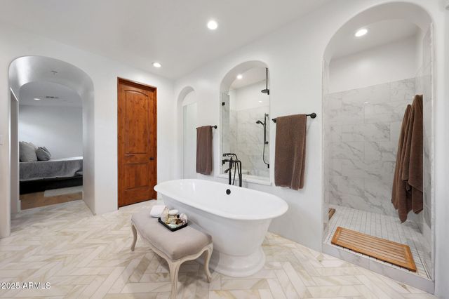 a bathroom with a sink a mirror and next to a window