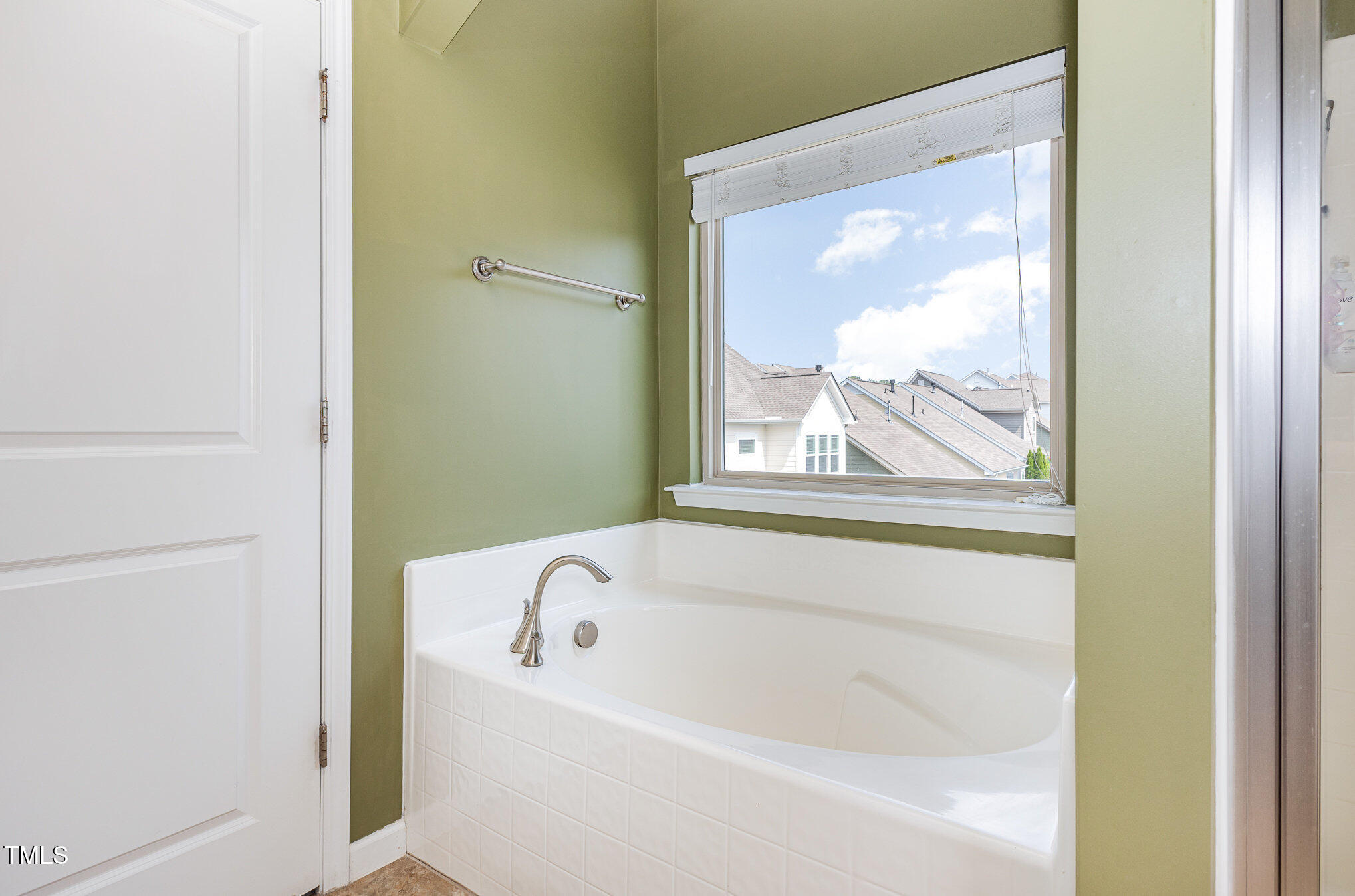 1427 Van Page Boulevard Raleigh, NC 27607 - Photo 16 of 28 a bathroom with a bathtub and window