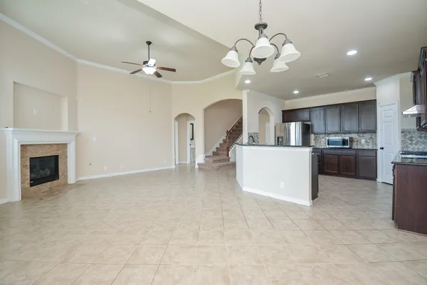 a view of a kitchen with a stove cabinets wooden floor and a chandelier