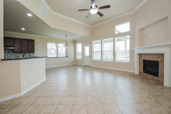 a view of an empty room with window and cabinet
